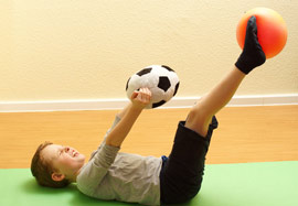 Ein Junge bei der Ergotherapie mit Bällen in Berlin